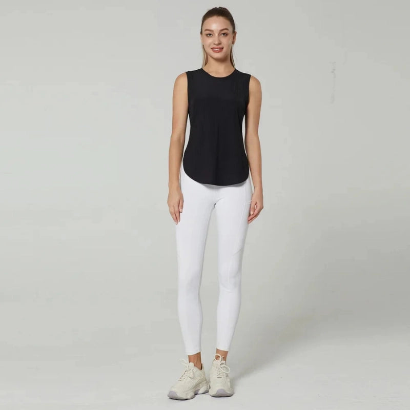 Débardeur de sport femme noir respirant porté avec legging blanc, vue entière, idéal pour le fitness, la musculation et le running