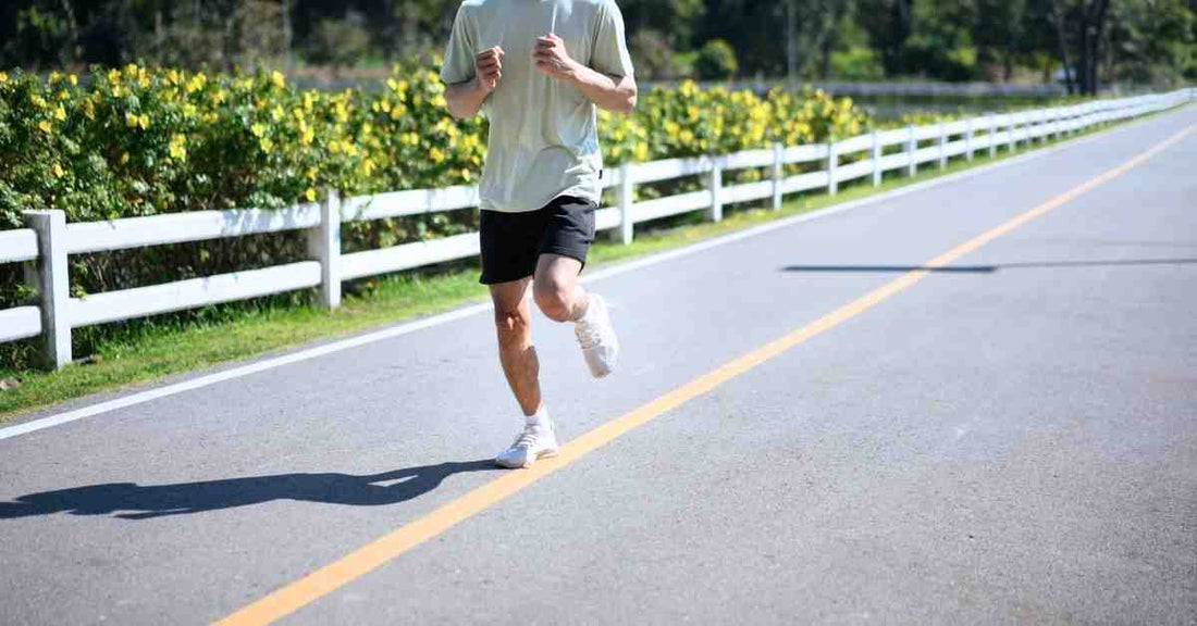 coureur homme courant sur route avec tenue de running respirante pour éviter les frottements pendant la course à pied