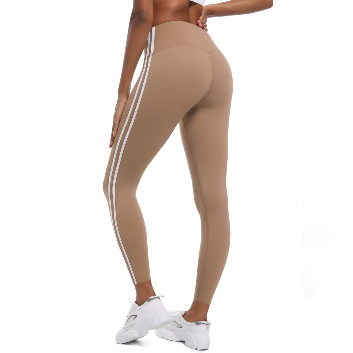 Legging de sport femme beige sable vue de profil avec bandes latérales et maintien confortable
