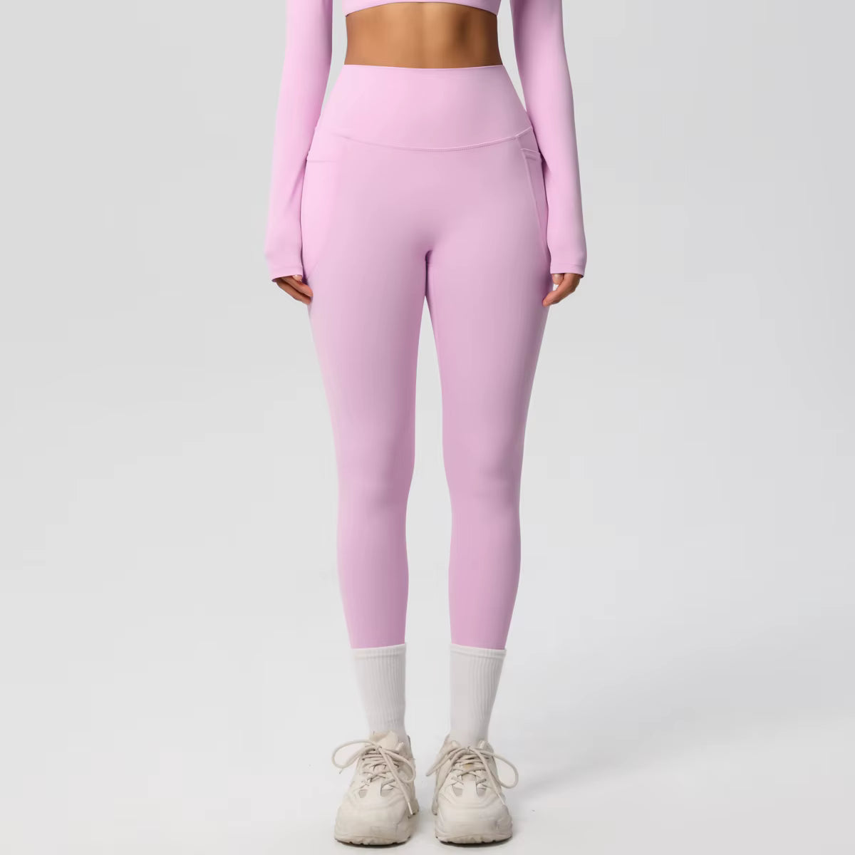 Legging de sport femme rose clair taille haute avec coupe ajustée et maintien confortable

