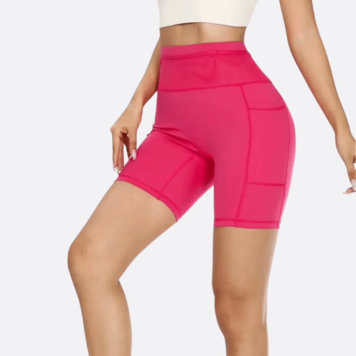 Short de compression femme rose taille haute avec poche latérale, maintien confortable et coupe gainante pour le sport