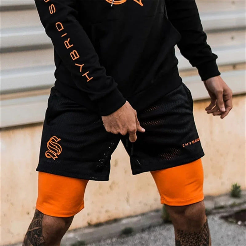 Short running homme noir 2 en 1 avec sous-short compression orange, tissu respirant en mesh pour entraînement intensif
