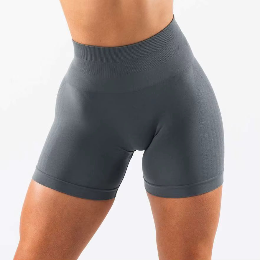 Short sport femme taille haute gris graphite, vue de face, tissu extensible et confortable pour l’entraînement.
