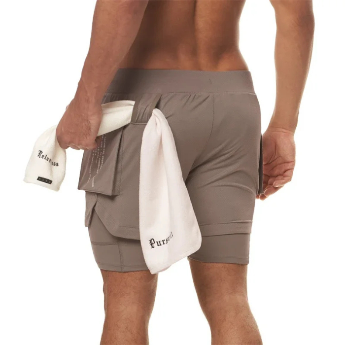 Short sport homme ECET marron – vue à plat avec poches zippées, cuissard intégré et finitions techniques.