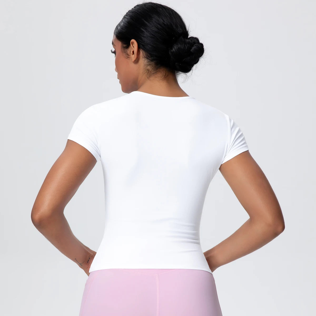 T-shirt de sport femme Arctic Ivory en vue arrière, coupe gainante, tissu respirant et extensible.
