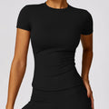 T-shirt sport femme gainant noir, coupe ajustée et respirante
