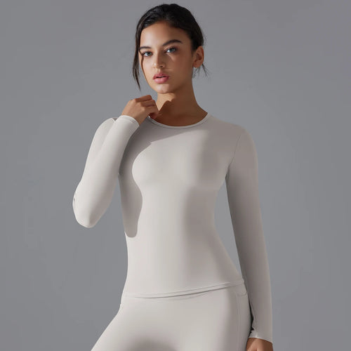 T-shirt de sport femme manches longues gainant gris clair, coupe slim extensible et respirante pour yoga fitness et entraînement
